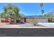 Charming single-story home with a well-maintained yard, desert landscaping, and solar panels on the roof at 1220 E Avenida Ellena St, Casa Grande, AZ 85122