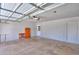 Spacious two car garage with white brick walls, white door, and garage door opener at 1220 E Avenida Ellena St, Casa Grande, AZ 85122