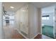 Hallway with wood floors leading to a kitchen with stainless steel appliances and a bedroom at 1220 E Avenida Ellena St, Casa Grande, AZ 85122