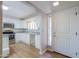 Bright kitchen featuring white cabinetry, stainless steel appliances, and a door with a decorative window at 1220 E Avenida Ellena St, Casa Grande, AZ 85122
