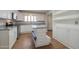Bright kitchen featuring white cabinets, stainless steel appliances, and an island with a seating area at 1220 E Avenida Ellena St, Casa Grande, AZ 85122