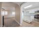 Open-concept kitchen seamlessly flowing into the living room with stainless steel appliances at 1220 E Avenida Ellena St, Casa Grande, AZ 85122
