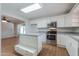 Bright kitchen featuring white cabinets, stainless steel appliances, countertops, and an island at 1220 E Avenida Ellena St, Casa Grande, AZ 85122