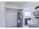 Utility area shows the water heater and laundry hookups with access to more storage at 1220 E Avenida Ellena St, Casa Grande, AZ 85122