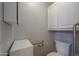 Small toilet room with white cabinet for storage, grab bars and white toilet at 1220 E Avenida Ellena St, Casa Grande, AZ 85122