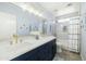 Elegant bathroom featuring double sinks, gold fixtures, quartz countertops, and modern shower at 12209 W Washington St, Avondale, AZ 85323