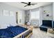 Charming bedroom with light blue walls, ceiling fan, rocking horses, and natural light at 12209 W Washington St, Avondale, AZ 85323