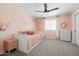 Cozy bedroom featuring a daybed, ceiling fan, soft pink decor, and ample storage space for a comfortable retreat at 12209 W Washington St, Avondale, AZ 85323