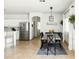 This dining area features a wooden table, black chairs, stylish lighting, and access to the kitchen, creating a welcoming space at 12209 W Washington St, Avondale, AZ 85323