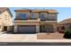 Two-story home showcasing a tile roof, neutral stucco, and a two-car garage at 12209 W Washington St, Avondale, AZ 85323