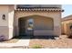 Inviting front porch with security screen door and a small desert landscaped yard at 12209 W Washington St, Avondale, AZ 85323