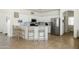 Bright kitchen featuring white cabinets, stainless steel appliances, a breakfast bar with seating, and tile flooring at 12209 W Washington St, Avondale, AZ 85323