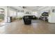 Open living room with large tile flooring, oversized windows, sliding door to the outdoor space and a fan at 12209 W Washington St, Avondale, AZ 85323