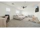 Comfortable living room featuring a large sectional sofa, ceiling fan, natural light, desk space, and play area at 12209 W Washington St, Avondale, AZ 85323