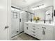 Modern primary bathroom with dual sinks, white cabinetry, and a glass-enclosed shower at 12209 W Washington St, Avondale, AZ 85323