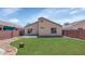 This backyard has a grass lawn and patio area perfect for entertaining at 12450 W Hearn Rd, El Mirage, AZ 85335