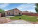 The backyard has a grass lawn, patio area, and a block wall fence at 12450 W Hearn Rd, El Mirage, AZ 85335