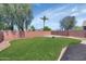 This backyard features a grass lawn and block wall fence at 12450 W Hearn Rd, El Mirage, AZ 85335