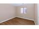 This bedroom features modern flooring and a window for natural light at 12450 W Hearn Rd, El Mirage, AZ 85335