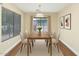 Well-lit dining room with neutral walls, wood floors and a view to the outside at 12450 W Hearn Rd, El Mirage, AZ 85335