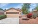 Single-story home featuring a two-car garage, desert landscaping, and a tile roof at 12450 W Hearn Rd, El Mirage, AZ 85335