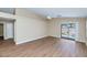 Bright living room with wood floors and large sliding glass doors to the backyard at 12450 W Hearn Rd, El Mirage, AZ 85335
