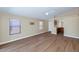 Spacious living room featuring wood floors, high ceilings, windows, and a ceiling fan at 12450 W Hearn Rd, El Mirage, AZ 85335