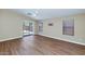 Bright living room with wood floors, high ceilings and sliding glass doors to the backyard at 12450 W Hearn Rd, El Mirage, AZ 85335