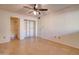 This bright bedroom features a ceiling fan, a closet and attached bathroom at 1331 W Baseline Rd # 120, Mesa, AZ 85202
