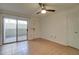 Bright living room featuring tile flooring, ceiling fan, and sliding glass doors leading to outdoor patio at 1331 W Baseline Rd # 120, Mesa, AZ 85202