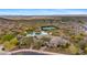 Community aerial shot featuring a pool, tennis court, and residential neighborhood amid the desert at 15037 N 114Th Way, Scottsdale, AZ 85255