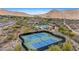 Aerial shot of community tennis courts nestled in a desert landscape with scenic mountain views at 15037 N 114Th Way, Scottsdale, AZ 85255