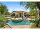 Inviting backyard oasis with pool, outdoor kitchen, lush landscaping, and ample seating at 15037 N 114Th Way, Scottsdale, AZ 85255
