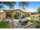Entertaining backyard boasts seating area, dining, manicured lawn, and lush plants and trees at 15037 N 114Th Way, Scottsdale, AZ 85255