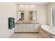 Spacious bathroom showcasing double sinks, decorative tile, soaking tub and recessed lighting at 15037 N 114Th Way, Scottsdale, AZ 85255