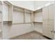 Walk-in closet with built-in shelving, drawers, and ample storage space at 15037 N 114Th Way, Scottsdale, AZ 85255