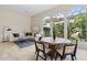 Stylish dining area featuring a unique table, modern chairs, and abundant natural light at 15037 N 114Th Way, Scottsdale, AZ 85255