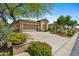 Exterior view of a single Gathering home and well-manicured front yard and driveway at 15037 N 114Th Way, Scottsdale, AZ 85255