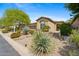 Charming home featuring desert landscaping, a two-car garage, and a covered front entryway at 15037 N 114Th Way, Scottsdale, AZ 85255