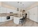 Spacious kitchen with granite countertops, a mosaic backsplash, white cabinetry, and a kitchen island at 15037 N 114Th Way, Scottsdale, AZ 85255