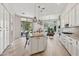 Bright kitchen with an island, granite countertops, pendant lights, and a large window view of the backyard at 15037 N 114Th Way, Scottsdale, AZ 85255