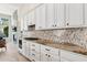 Bright kitchen with granite countertops, a mosaic backsplash, and white cabinetry at 15037 N 114Th Way, Scottsdale, AZ 85255