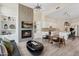 Open-concept living room with a fireplace, built-in shelving, wood floors, and access to the modern kitchen at 15037 N 114Th Way, Scottsdale, AZ 85255