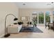 Bright and airy living room with a comfortable sectional sofa and large windows at 15037 N 114Th Way, Scottsdale, AZ 85255