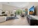 Open-concept living room with ample natural light, modern furnishings, and tile flooring at 15037 N 114Th Way, Scottsdale, AZ 85255