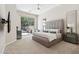 Main bedroom with a large bed, large glass sliding doors that let in natural light, and an outdoor patio at 15037 N 114Th Way, Scottsdale, AZ 85255