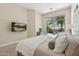 Bedroom featuring a cozy bed, sliding glass doors, and a view of the backyard patio at 15037 N 114Th Way, Scottsdale, AZ 85255