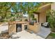 Outdoor kitchen features a built-in grill, refrigerator, and counter space for alfresco dining at 15037 N 114Th Way, Scottsdale, AZ 85255