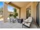 Comfortable covered patio with a cozy fire pit and stylish seating offers an inviting outdoor space at 15037 N 114Th Way, Scottsdale, AZ 85255