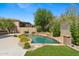 Beautiful backyard pool with stone accents, mature trees, and lush landscaping creates a private oasis at 15037 N 114Th Way, Scottsdale, AZ 85255